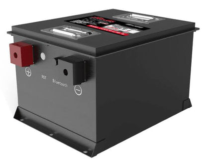 A black rectangular battery with a metal mounting base, featuring a red positive terminal, a black negative terminal, and labels for RST and Bluetooth on the side.