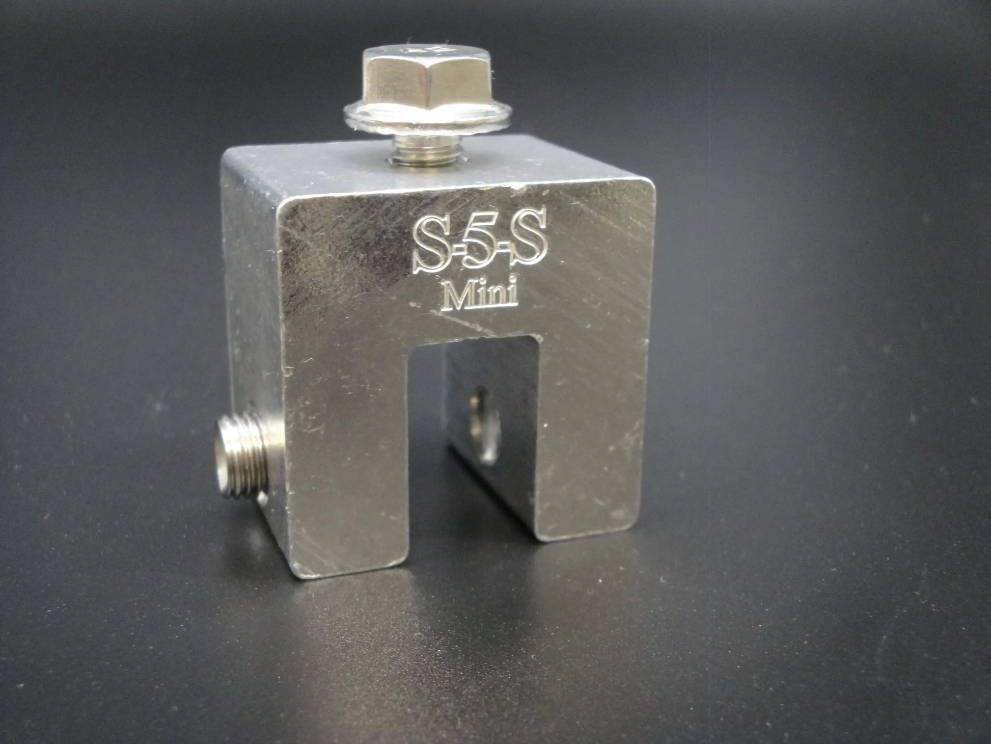 Metal block with 'S5S Mini' branding on a dark background