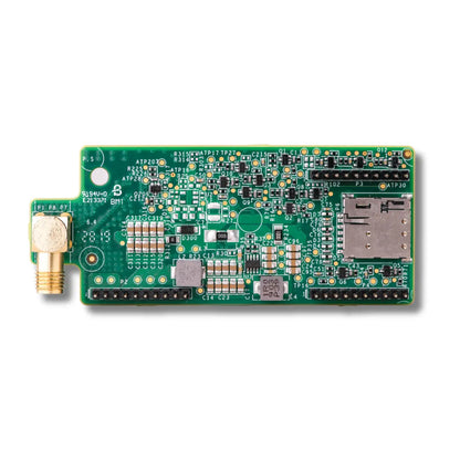 A green electronic circuit board with various electronic components, a gold-plated SMA connector on the left, and an SD card slot on the right, photographed on a clean white background.