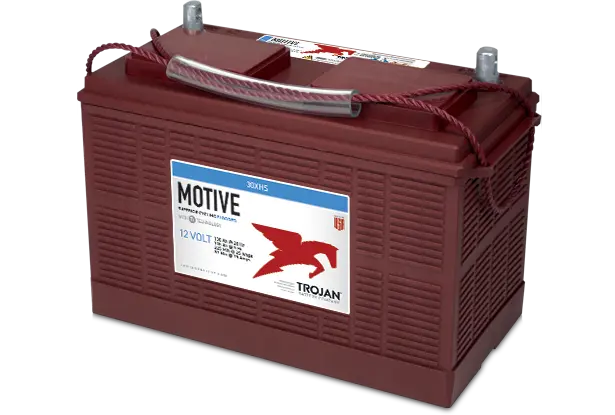 A red Trojan Motive flooded lead acid battery with branding and product information printed on the side.