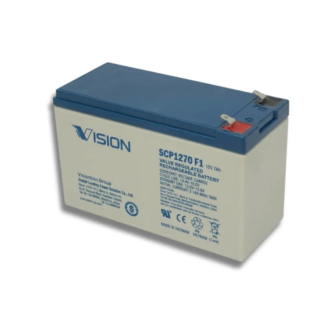 A Vision brand 12V 7Ah regular-seable battery, model SCP1270 F1, featuring a blue top cover and a light gray side panel with printed specifications and safety icons.